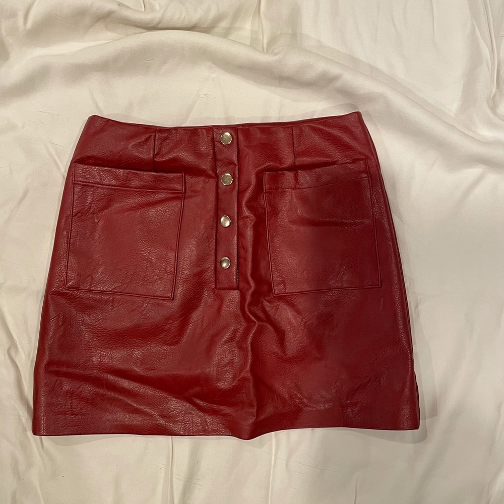 Red A-line skirt with gold buttons